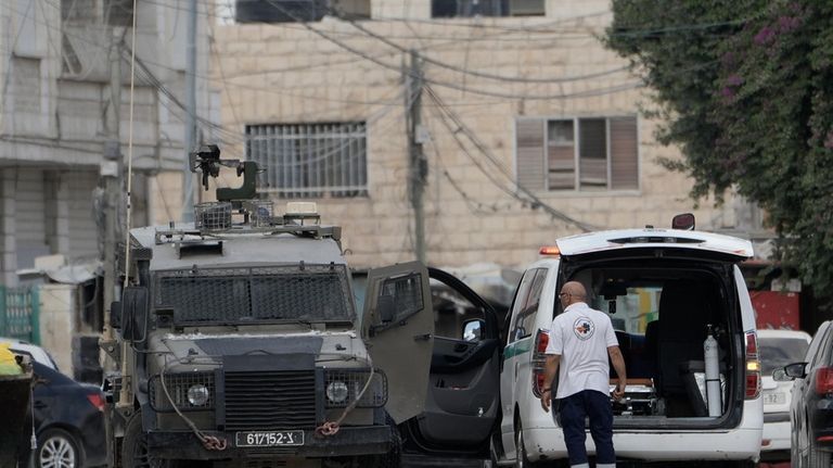 Members of the Israeli forces inside an armoured vehicle check...