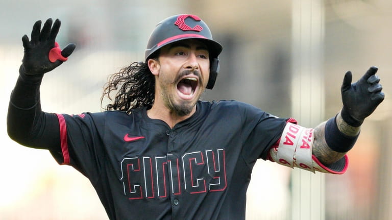 Cincinnati Reds' Jonathan India reacts as he rounds the bases...