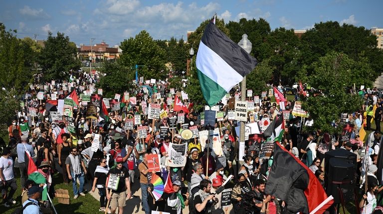 Protesters march to the Democratic National Convention after a rally...