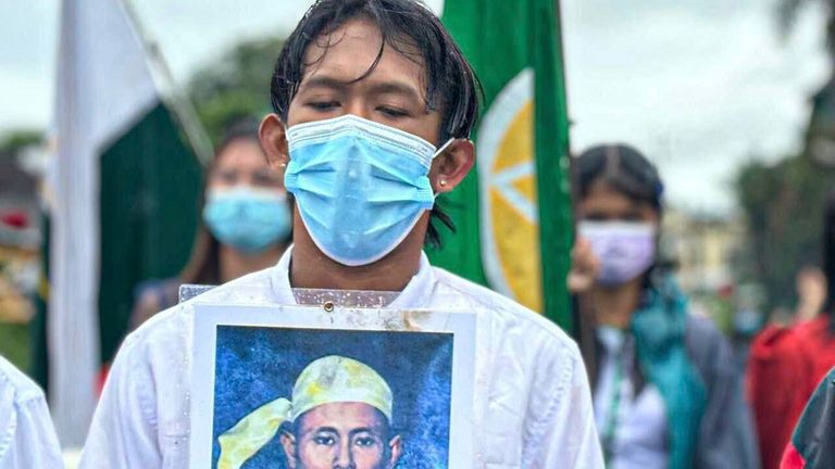 A demonstrator holds a portrait of Gen. Aung San, during...