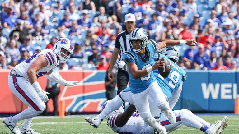 Carolina Panthers quarterback Bryce Young scrambles in the first half...