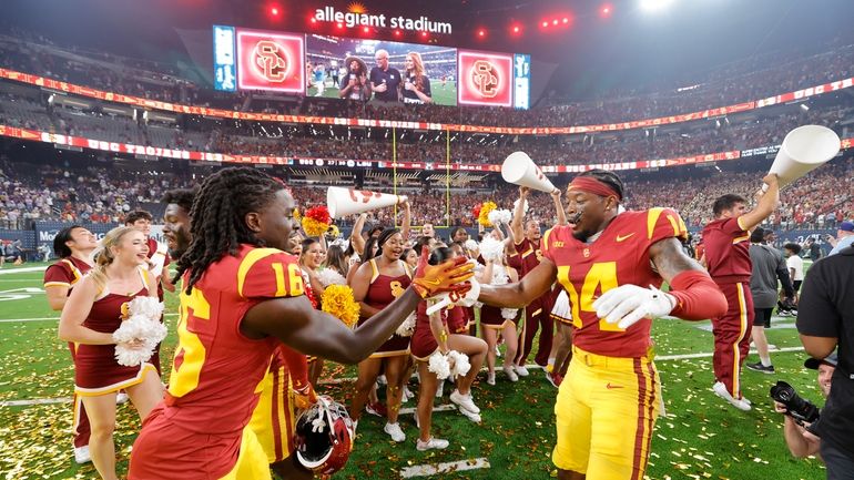 Southern California cornerbacks Prophet Brown (16) and Jacobe Covington (14)...