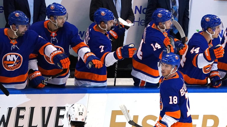 Anthony Beauvillier #18 of the Islanders celebrates with his teammates...