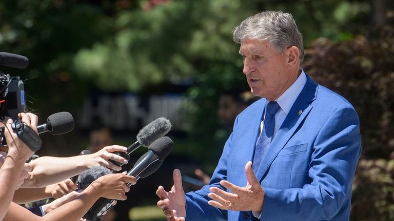 Sen. Joe Manchin, D-W.Va., takes a moment to talk with...