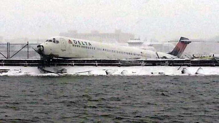 Plane skids off LaGuardia runway, slams into fence