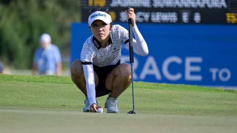 Lydia Ko prepares to putt on the 18th green during...