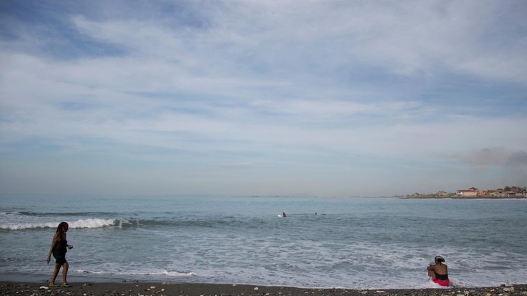 People gather on Wickie Wackie Beach in Kingston, Jamaica, Oct....