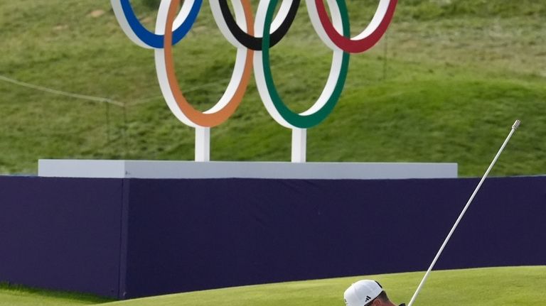 Xander Schauffele, of the United States, acknowledges the crowd after...