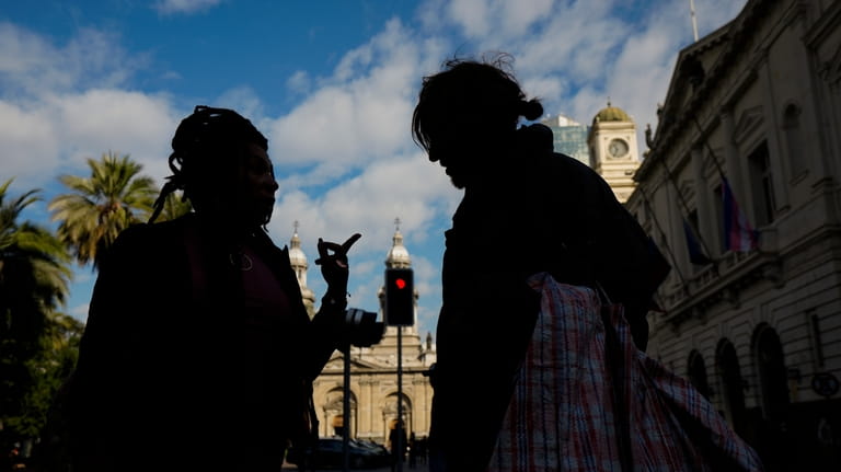 Homeless person Paris Lopez, right, talks with a member of...