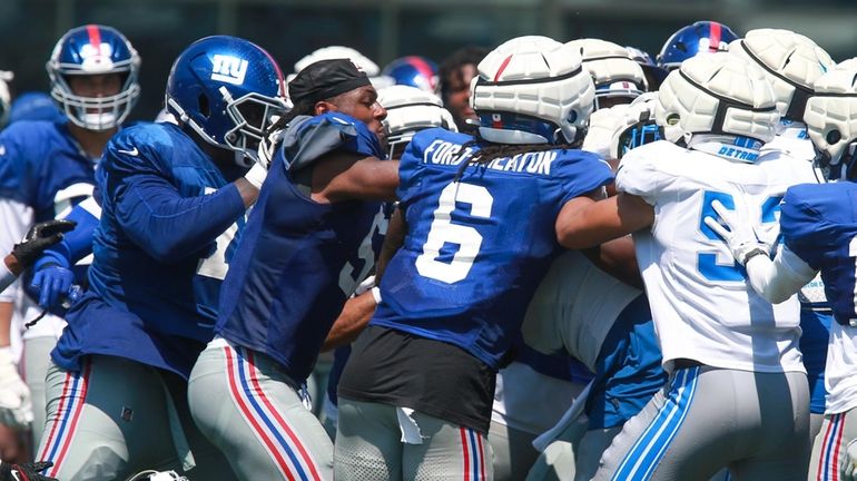 Players scuffle during the New York Giants Training Camp against...