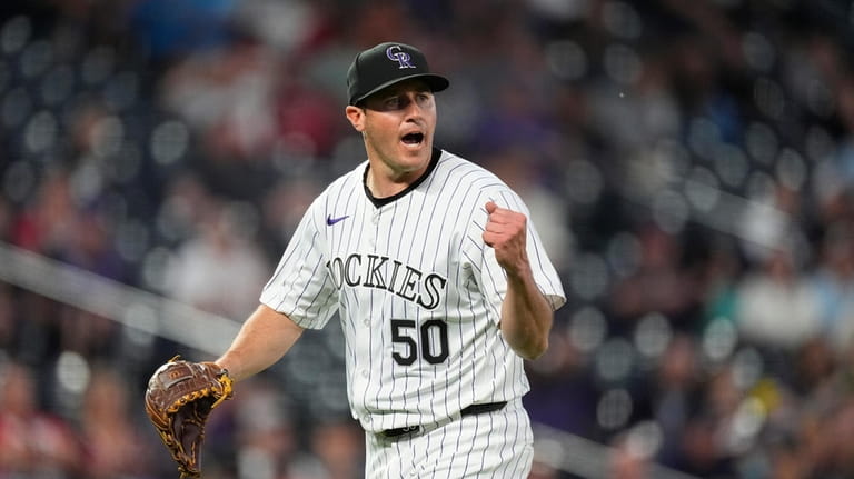 Colorado Rockies starting pitcher Ty Blach reacts after getting Cleveland...