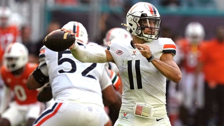 Virginia quarterback Tony Muskett (11) stands back to pass during...