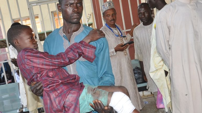 A victim of army drones attack receives treatment at a...