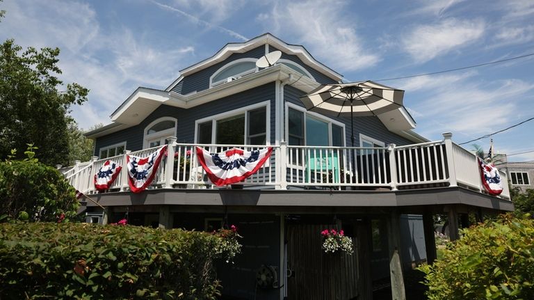 The elevated, wrap-around deck offers both views of the water...