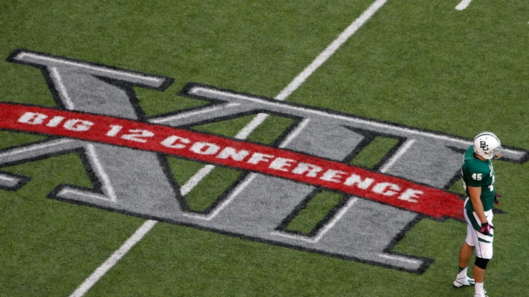 Baylor's Matt Ritchey stands by the Big 12 Conference logo...