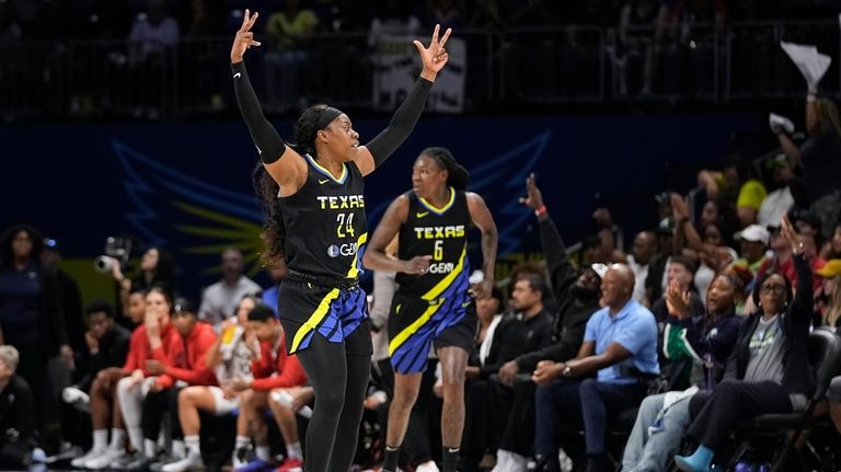 Dallas Wings guard Arike Ogunbowale (24) celebrates after forward Natasha...