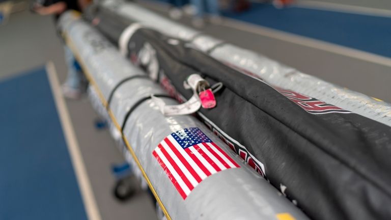 An American flag and luggage tags decorate pole vault bags...