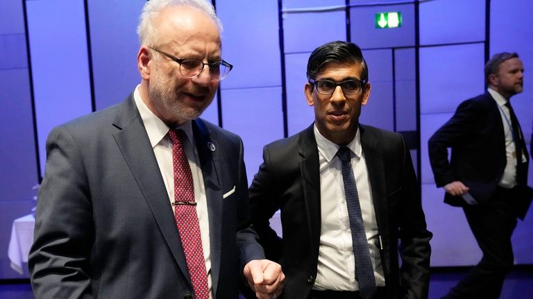 Britain's Prime Minister Rishi Sunak, center, speaks with Latvia's President...