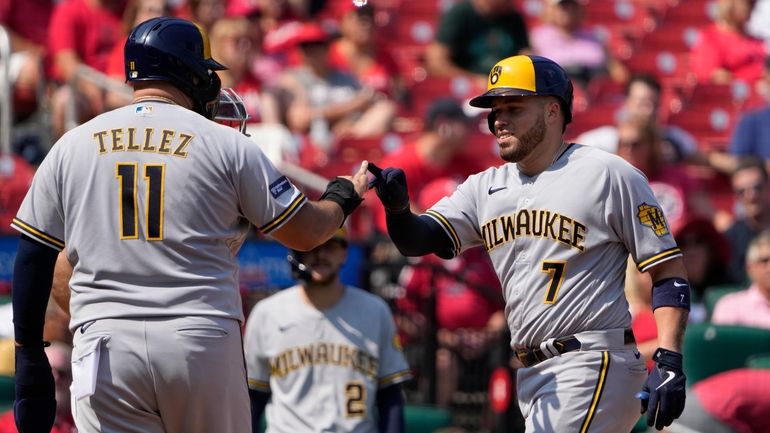 Milwaukee Brewers' Victor Caratini (7) is congratulated by teammate Rowdy...