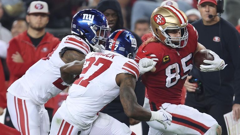 49ers tight end George Kittle runs against Giants safety Jason...