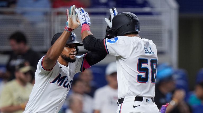 Miami Marlins' Derek Hill (58) is congratulated by Otto Lopez...