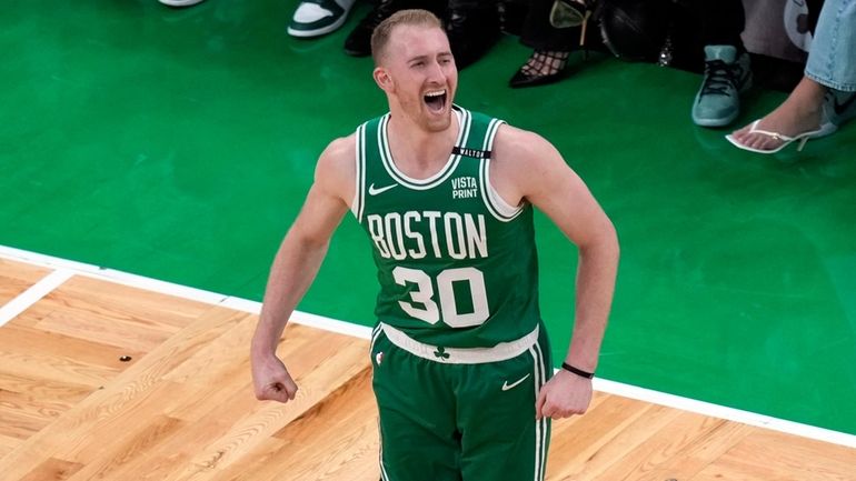 Boston Celtics' Sam Hauser reacts after making a 3-point basket...