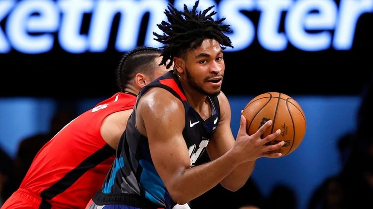 Nets guard Cam Thomas handles the ball against Rockets forward Dillon...