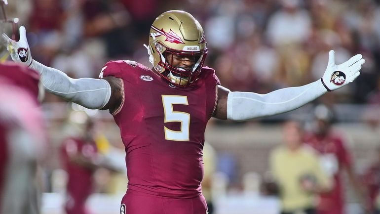 Florida State defensive end Jared Verse (5) gets fired up...