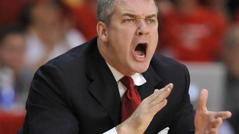 Stony Brook coach Steve Pikiell directs his team from the...