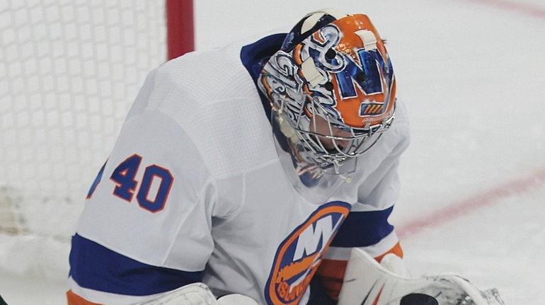 The Islanders' goalie Semyon Varlamov stops a shot by the Wild's...