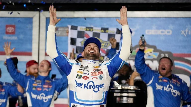 Ricky Stenhouse Jr. celebrates in Victory Lane after winning the...