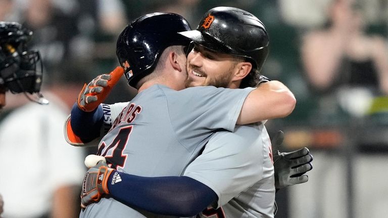 Detroit Tigers' Zach McKinstry, right, celebrates his two-run home run...