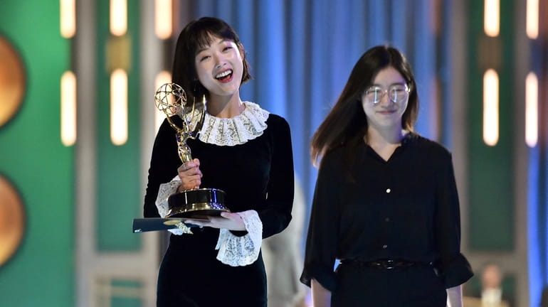Lee You-mi, left, and her translator walk backstage after Lee's Emmy...