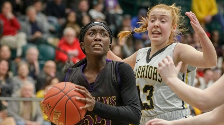 Carly Bolivar #33 of Sewanhaka drives past Megan Lucey #13...