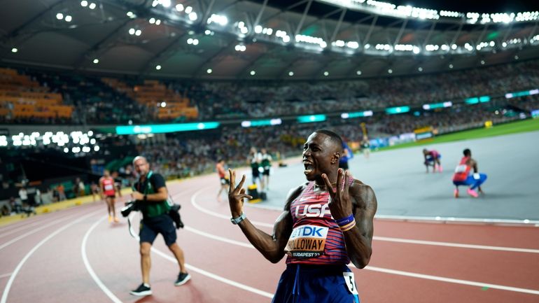 Grant Holloway, of the United States, reacts after winning the...