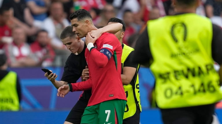 A pitch invader tries to take a selfie with Portugal's...