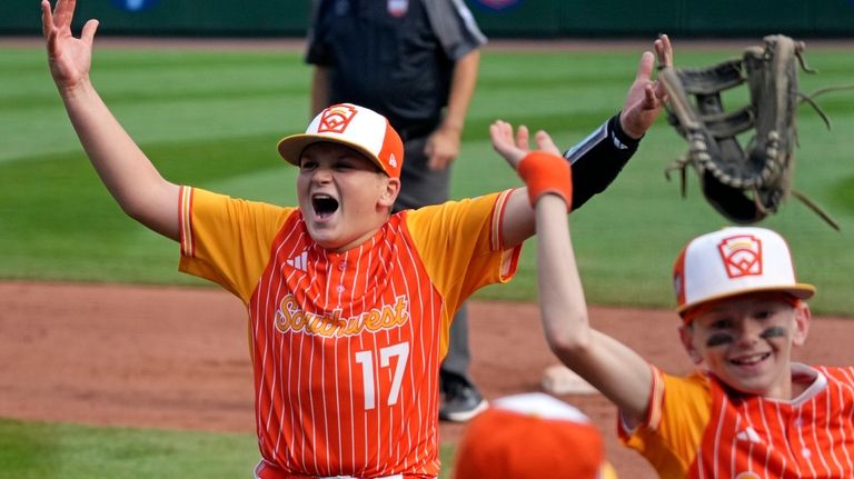 Boerne, Texas' Cooper Hastings (17) celebrates with teammates after getting...