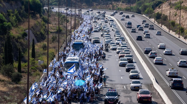 Israelis march along Highway 1 on their way to Jerusalem...