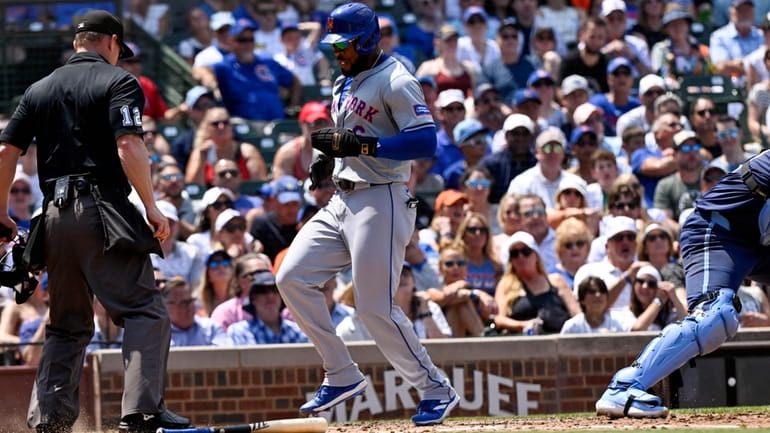 New York Mets' Starling Marte scores during the third inning...