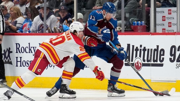 Colorado Avalanche right wing Valeri Nichushkin, right, drives past Calgary...