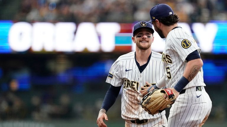 Milwaukee Brewers' Brice Turang, left, is congratulated by Garrett Mitchell...