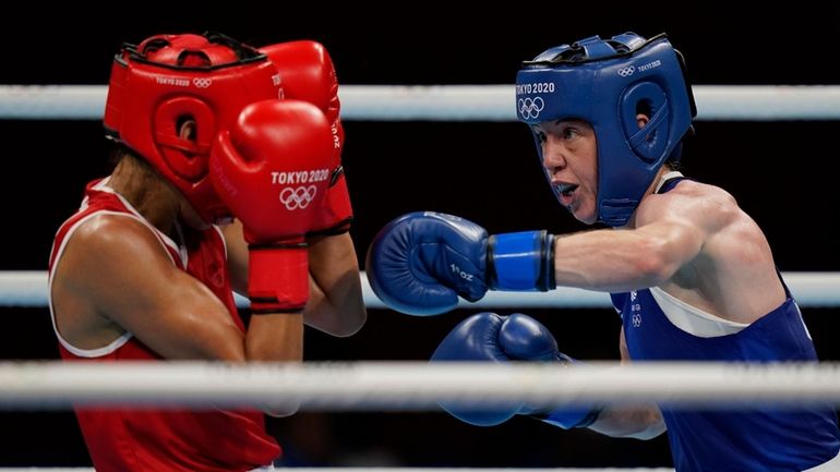 Morrocco's Rabab Cheddar, left, exchanges punches with Britains' Charley-Sian Davison...