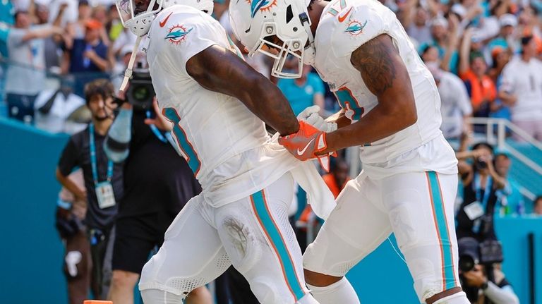 Miami Dolphins wide receiver Tyreek Hill (10) holds his hands...