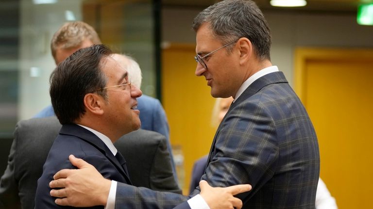 Spain's Foreign Minister Jose Manuel Albares Bueno, left, speaks with...