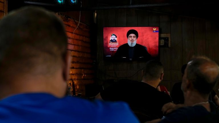 People listen to a speech by Hezbollah leader Sayyed Hassan...