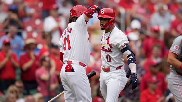 St. Louis Cardinals' Masyn Winn (0) is congratulated by teammate...