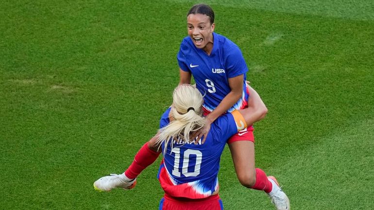 Mallory Swanson, of the United States, up, celebrates with Lindsey...