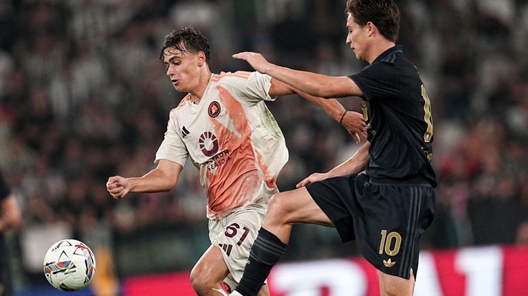 Roma's Niccolò Pisilli, left, fights for the ball against Juventus'...