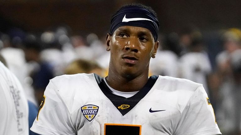 Toledo quarterback Dequan Finn walks the sidelines during an NCAA...