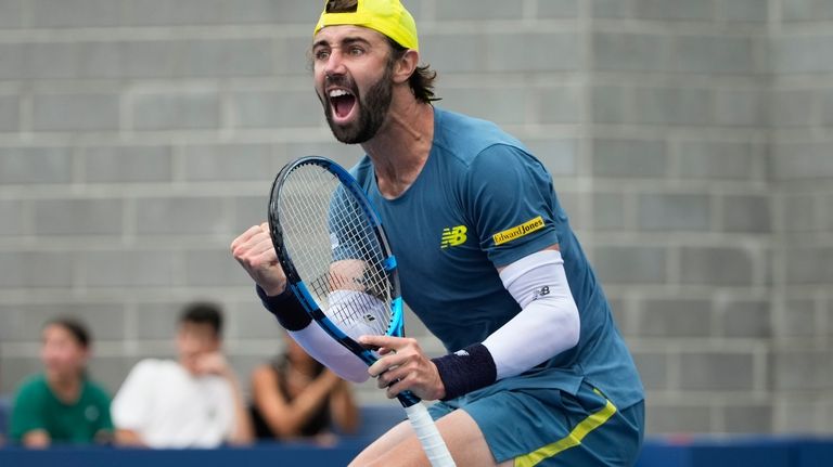 Jordan Thompson, of Australia, reacts after scoring a point against...